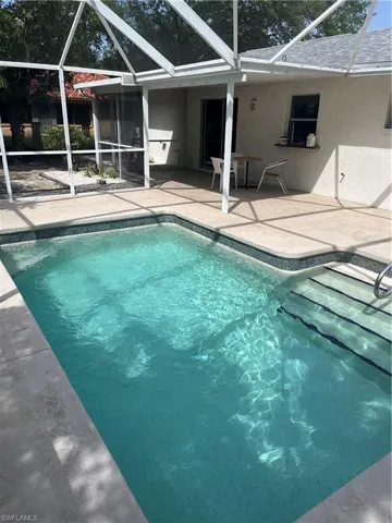Pool with a lanai and a patio area