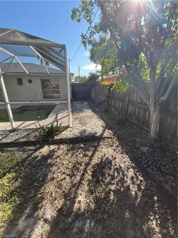 View of yard featuring a fenced backyard, a fenced in pool, and a lanai