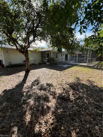 Rear view of property featuring a lanai