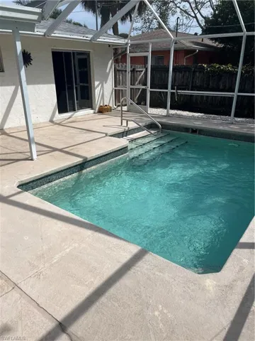 View of pool with a fenced in pool, a patio, a lanai, and fence