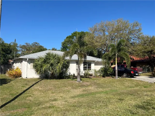 View of front of home with a front lawn and stucco siding