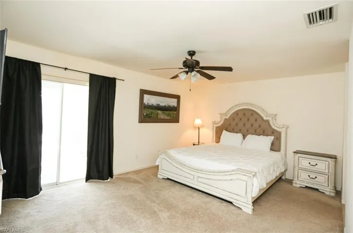 Bedroom with light carpet, access to outside, and ceiling fan