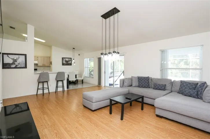 Living room featuring lofted ceiling and light hardwood / wood-style flooring