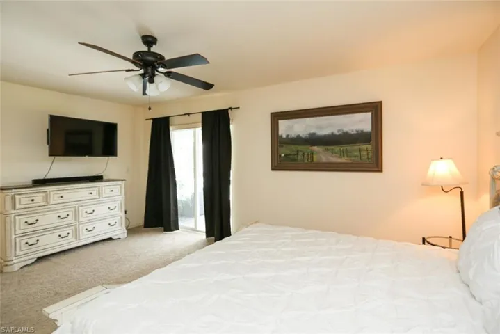 Bedroom featuring ceiling fan and light colored carpet