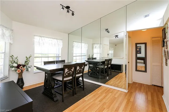 Dining room featuring hardwood / wood-style floors and track lighting