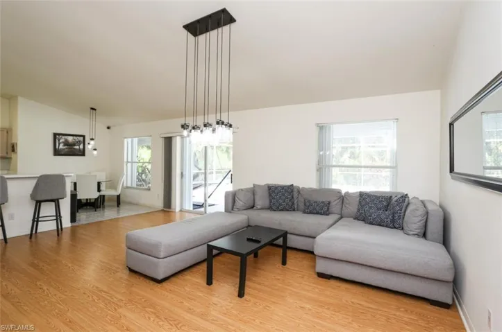 Living room featuring lofted ceiling and light wood-type flooring