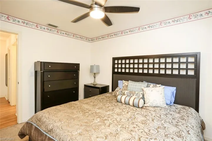 Carpeted bedroom with ceiling fan