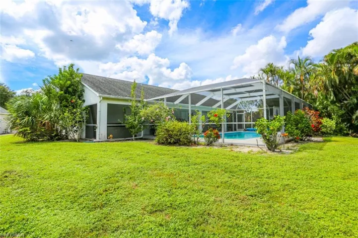 View of yard with a lanai