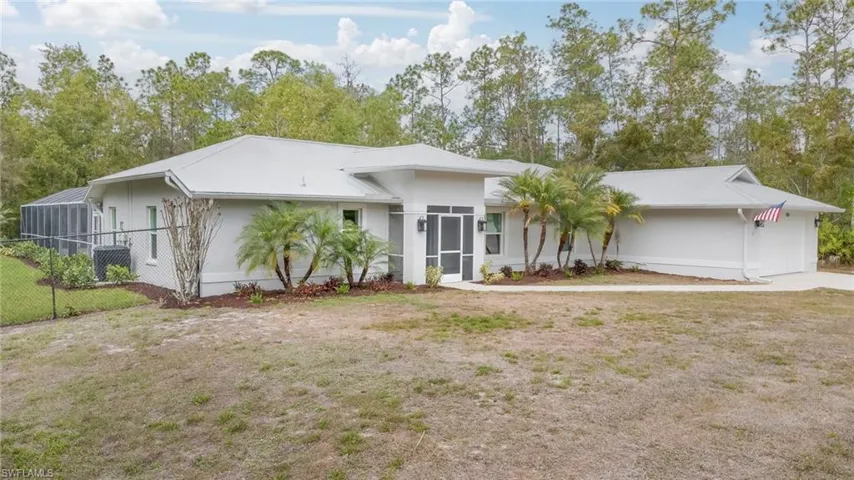 View of front facade with an attached garage and a sunroom