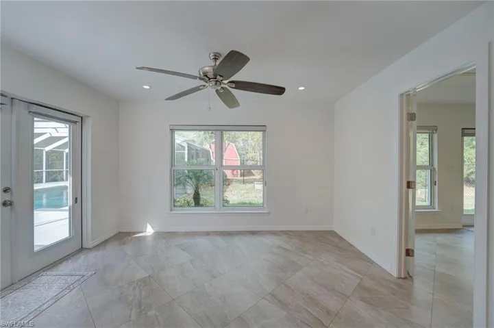 Spare room with a ceiling fan, recessed lighting, and french doors