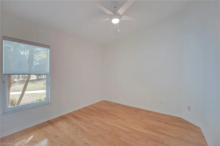 Empty room featuring light wood finished floors and ceiling fan