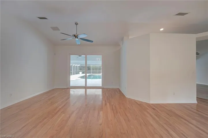 Unfurnished room featuring light wood-type flooring, ceiling fan, and recessed lighting