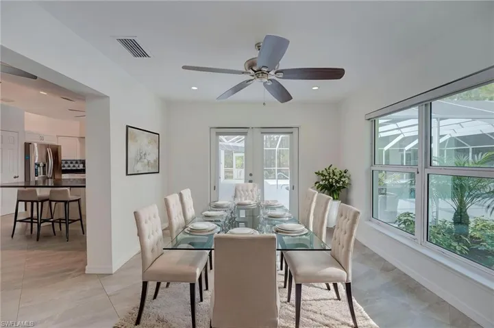 Dining area with a ceiling fan and french doors