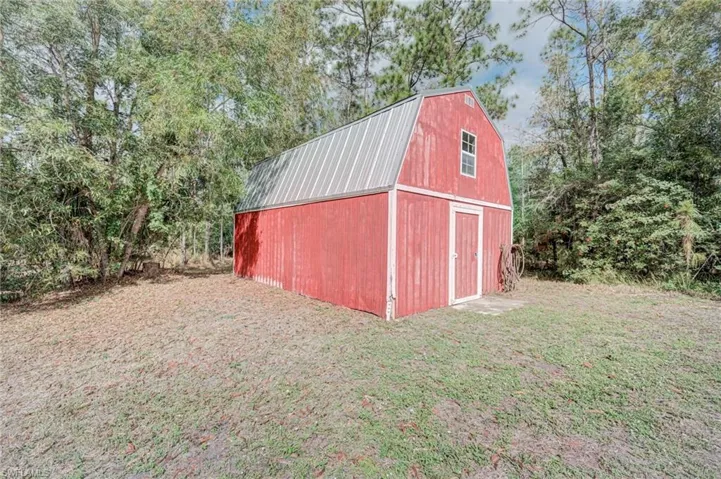 View of barn with a yard