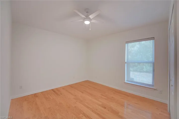 Unfurnished room featuring light wood finished floors and a ceiling fan