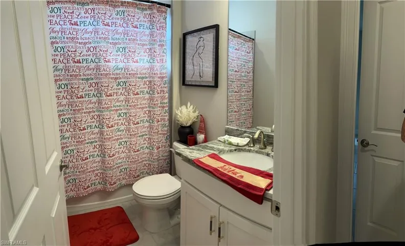 Bathroom featuring a vanity with a white countertop, undermount sink, and brushed nickel faucet