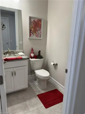 Vanity with granite-style countertop, undermount sink, and brushed nickel faucet