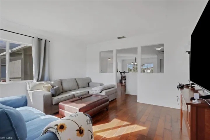 Living room with hardwood / wood-style flooring