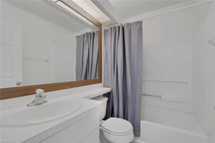 Full guest bathroom with vanity and shower / bath combination with curtain