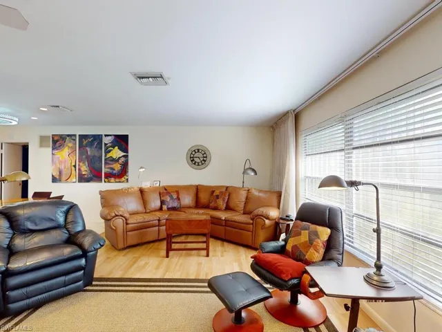 Living room with light hardwood / wood-style flooring