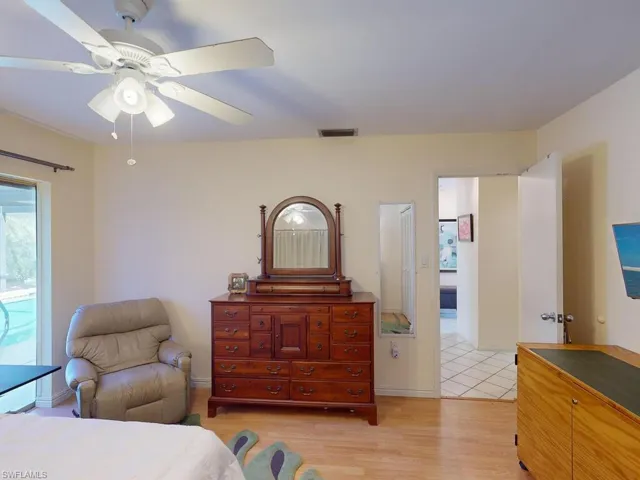 Bedroom with ceiling fan and light hardwood / wood-style flooring