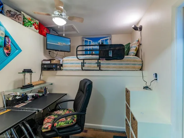 Carpeted office featuring ceiling fan