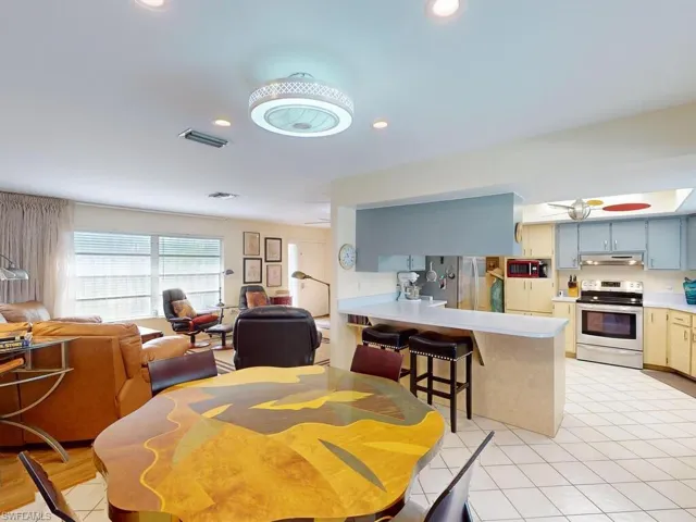 Tiled dining room featuring ceiling fan