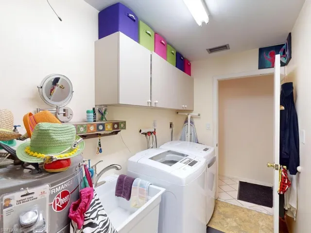 Laundry area featuring cabinets and separate washer and dryer
