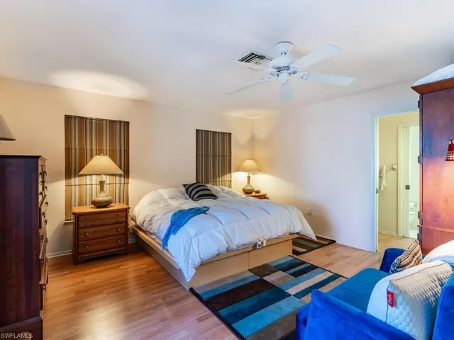 Bedroom with light hardwood / wood-style floors and ceiling fan