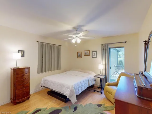 Bedroom featuring ceiling fan, light hardwood / wood-style floors, and access to exterior