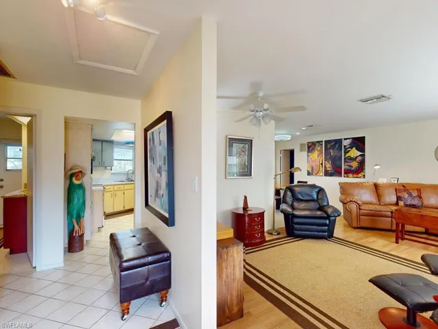 Tiled living room with a healthy amount of sunlight, sink, and ceiling fan