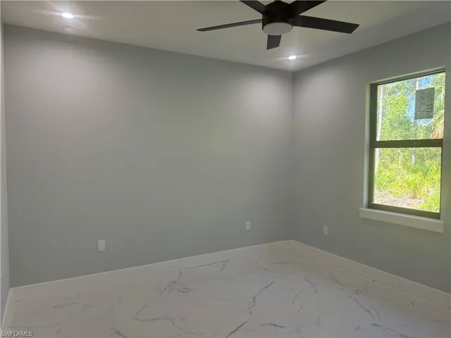 2nd bedroom featuring ceiling fan and a large  amount of sunlight