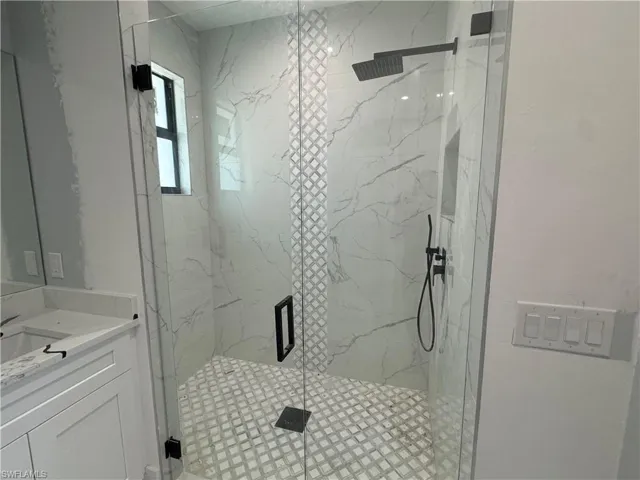 Bathroom featuring walk in shower and vanity