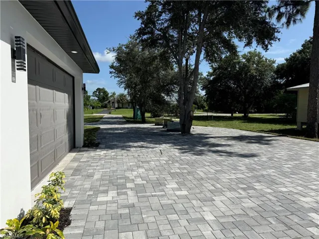 180 Ft Paved driveway with tree isle and two car parking space