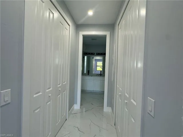 hall to the Owner's bathroom with his and her's Closets