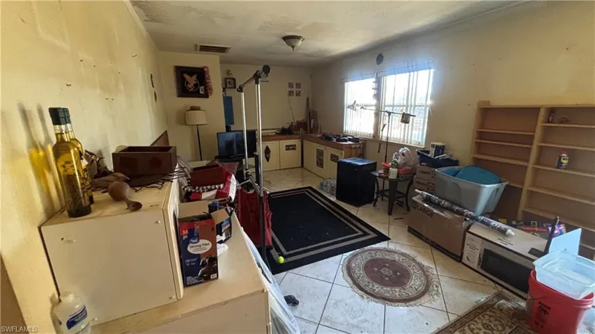 Miscellaneous room featuring light tile patterned flooring