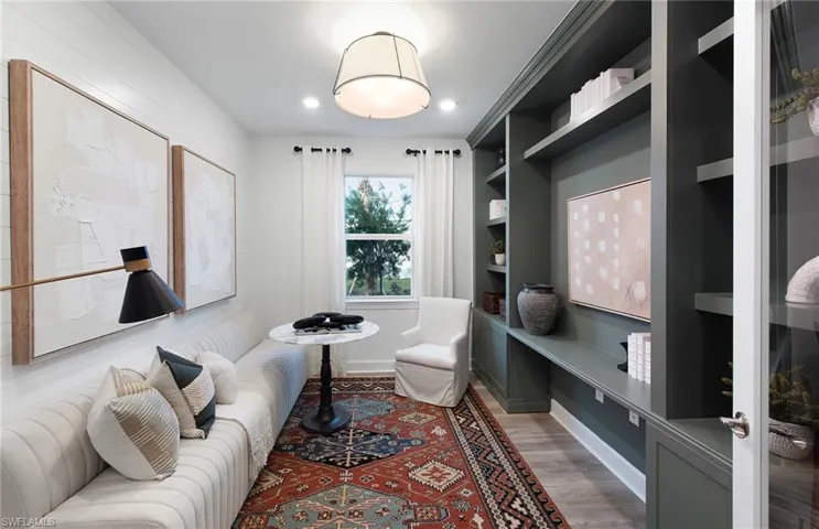 Living room featuring built in features and hardwood / wood-style floors