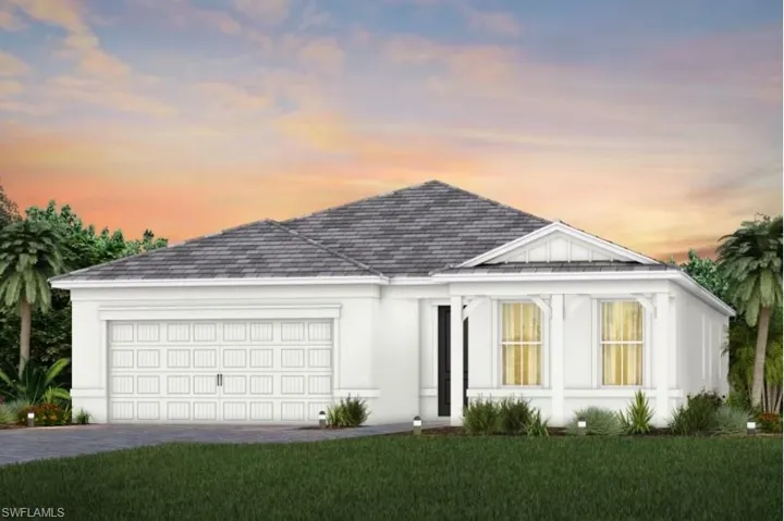 View of front of property featuring a garage and a yard