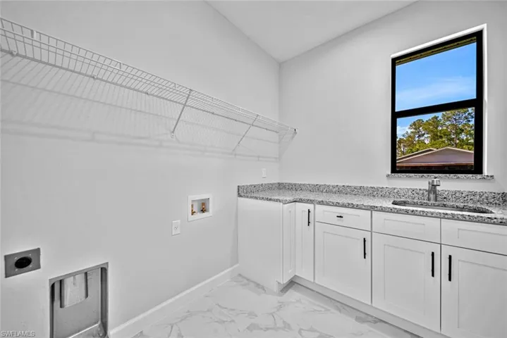 Huge Laundry room with abundant storage and utility sink