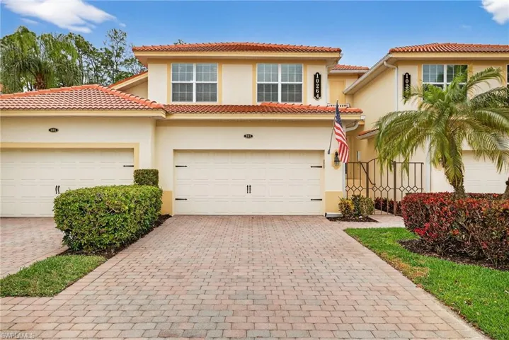 Mediterranean / spanish house with stucco siding, decorative driveway, a tiled roof, and a garage