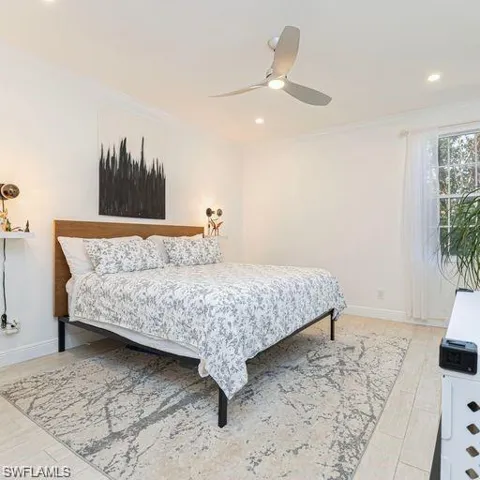 Bedroom featuring ceiling fan, crown molding, and recessed lighting