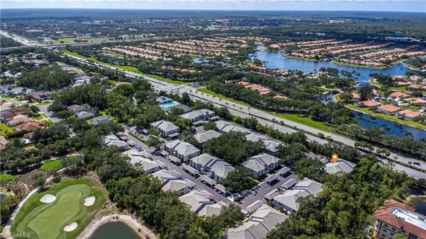 Aerial perspective of suburban area featuring a large body of water