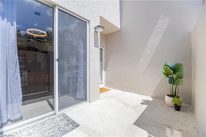 Property entrance featuring stucco siding