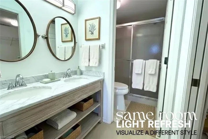 Full bath featuring double vanity and a shower stall