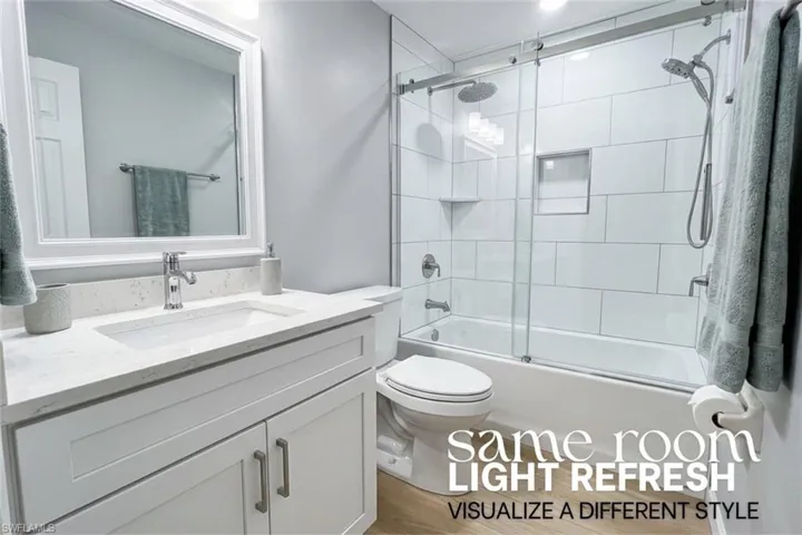 Bathroom featuring vanity and enclosed tub / shower combo
