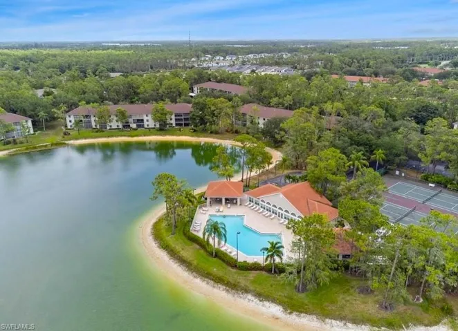 Aerial view of a pool area and a large body of water