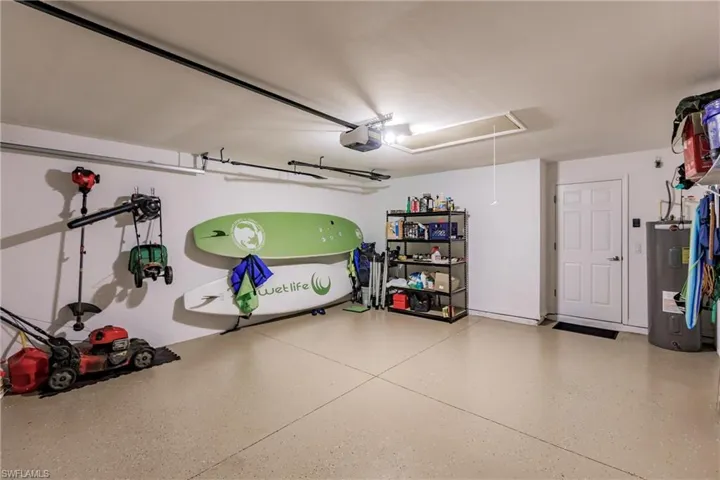 Garage with a garage door opener and electric water heater