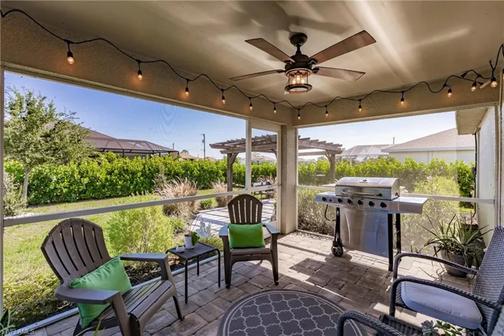 View of patio featuring a grill, a pergola, and ceiling fan