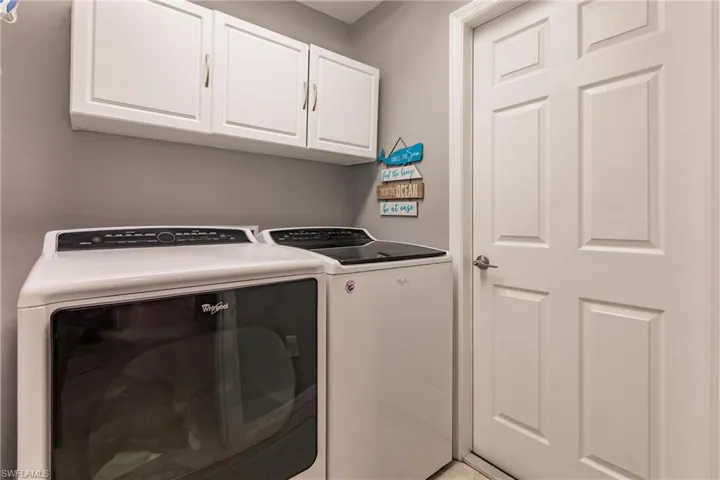 Laundry area with washer and dryer and cabinets