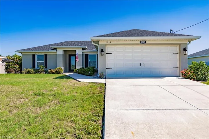 Ranch-style house with a garage and a front yard